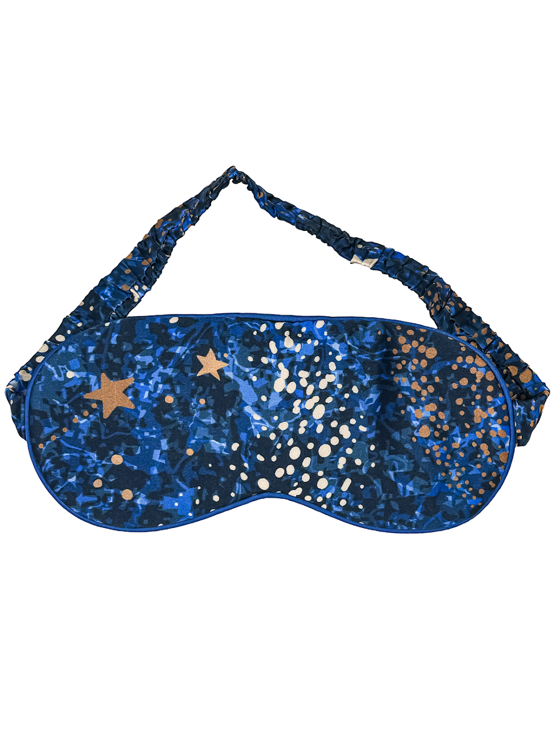Vista frontal del antifaz para dormir de seda Cielo Nocturno en azul con estampado de estrellas doradas.