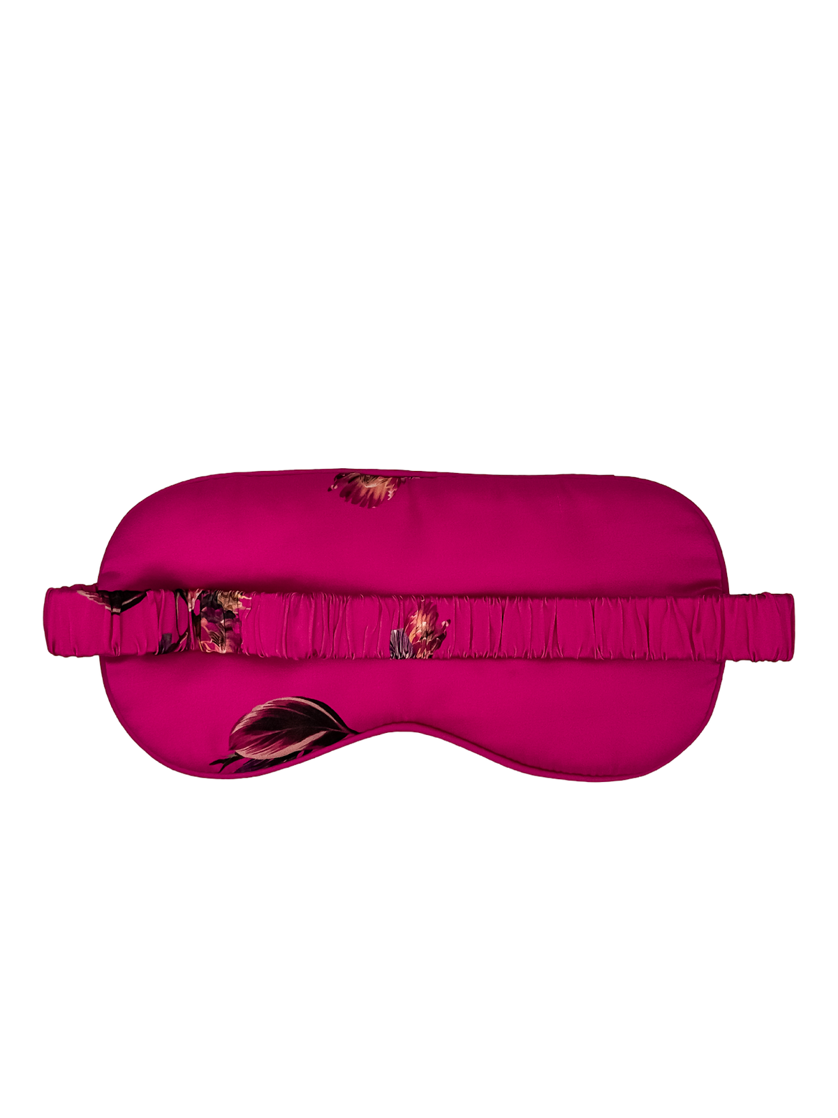 Parte posterior de un antifaz para dormir de seda morera color fucsia con estampado floral y banda elástica